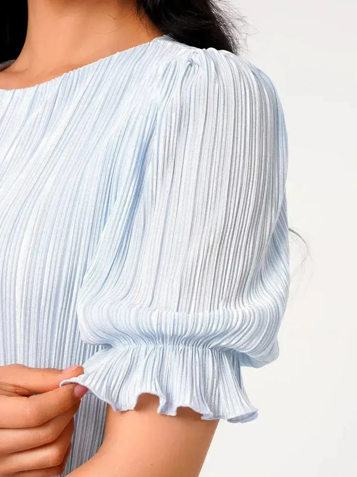 Angel Maxi Dress featuring light blue pleated fabric and elegant puff sleeves detailing.