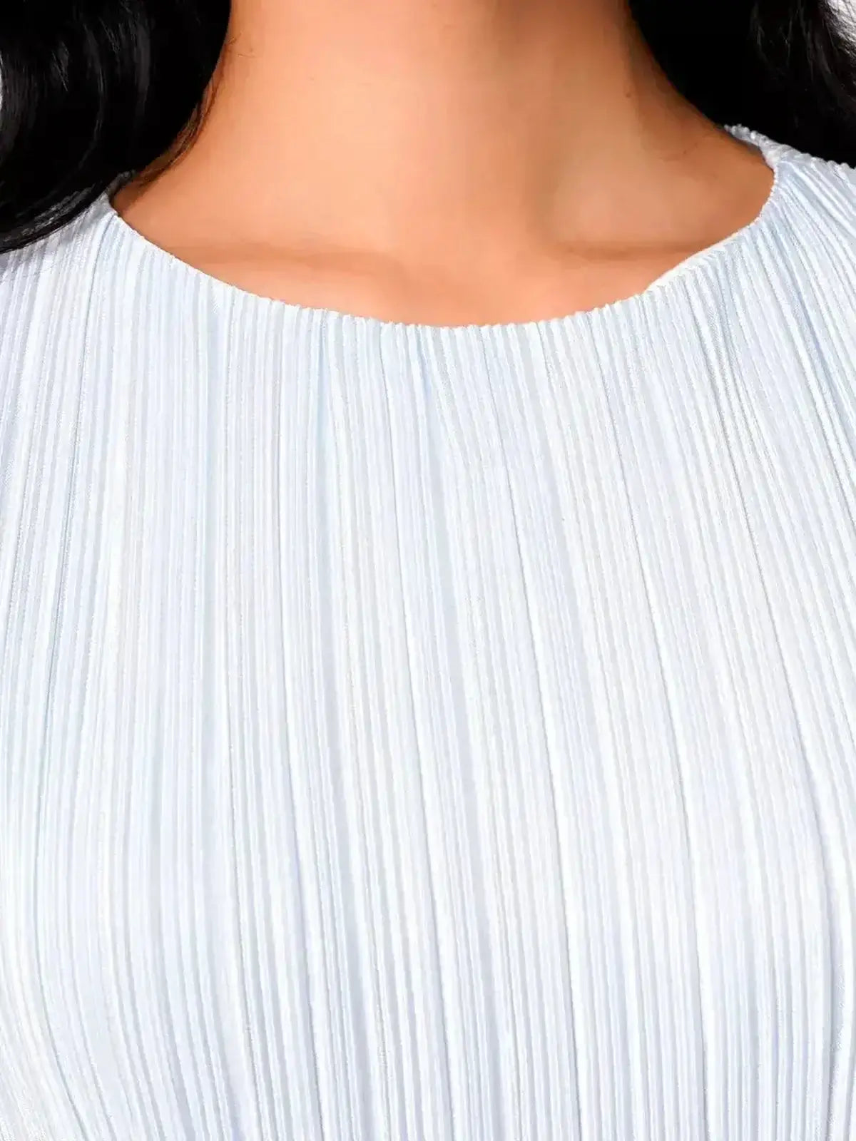 Close-up of the Angel Maxi Dress in light blue pleated fabric showcasing the elegant neckline and texture.