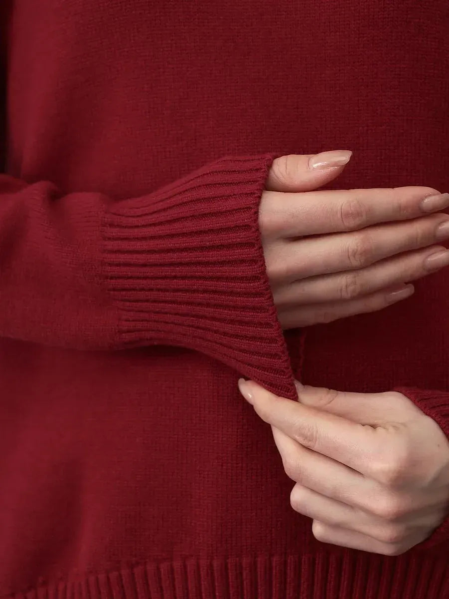 Arden Sweater detail showcasing a burgundy turtleneck with stylish ribbed cuffs by Lauven.