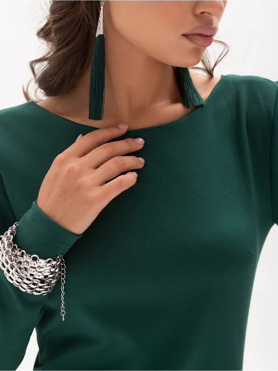 Close-up of a model wearing the Aurora Midi Dress by Lauven, showcasing its elegant emerald fabric and stylish accessories.