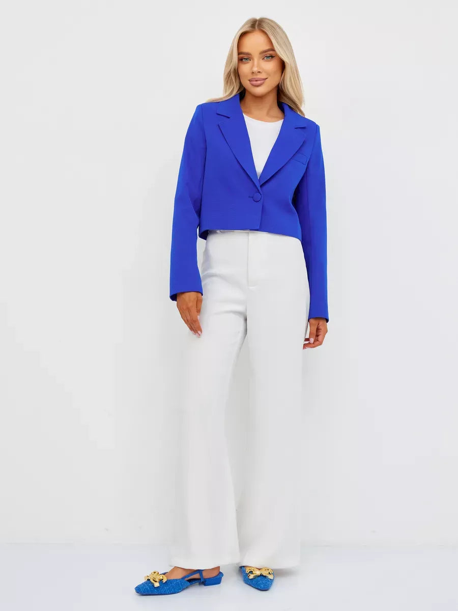 Azure Blazer from Lauven, featuring a cropped silhouette in vibrant electric blue, styled with white pants.