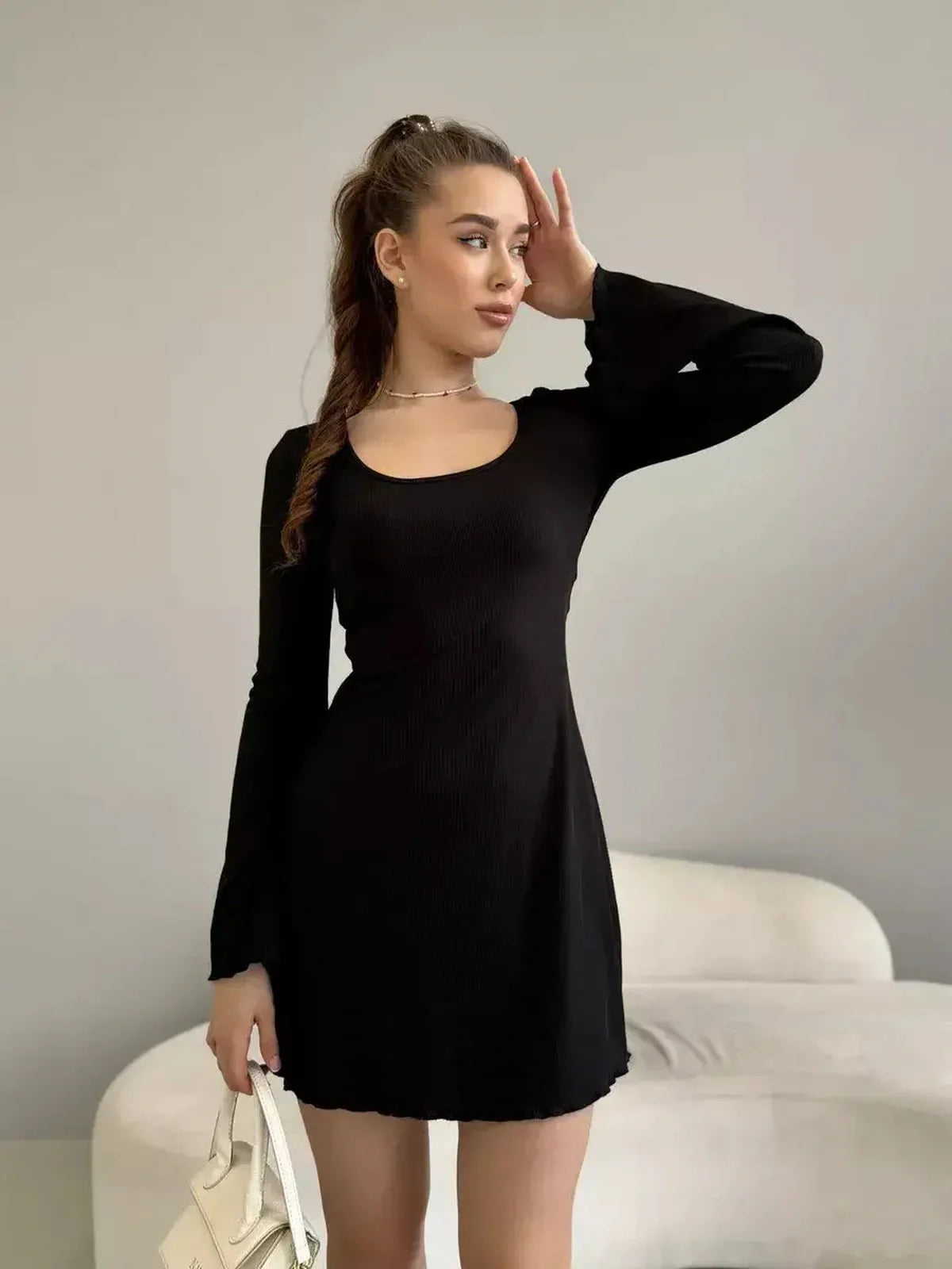 Emily Mini Dress by Lauven – Black ribbed knit with square neckline and flared cuffs, perfect for any occasion.