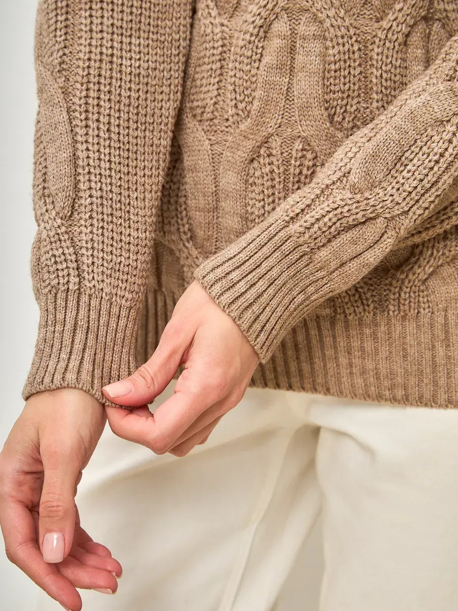 Cappuccino Knitwear by Lauven, showcasing an oversized wool-blend turtleneck sweater in a warm beige tone.