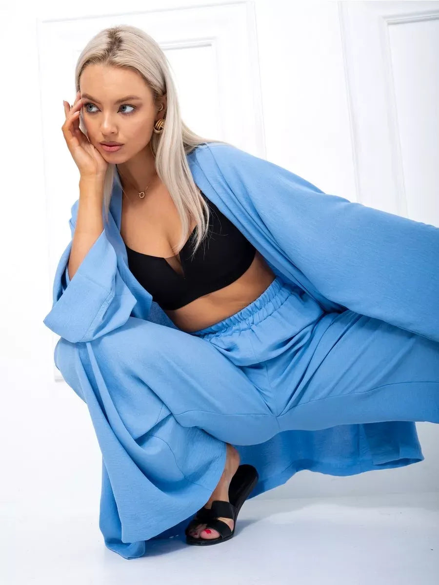 Model wearing the Celeste Suit Set by Lauven, featuring a soft blue oversized two-piece set with a kimono and palazzo pants.