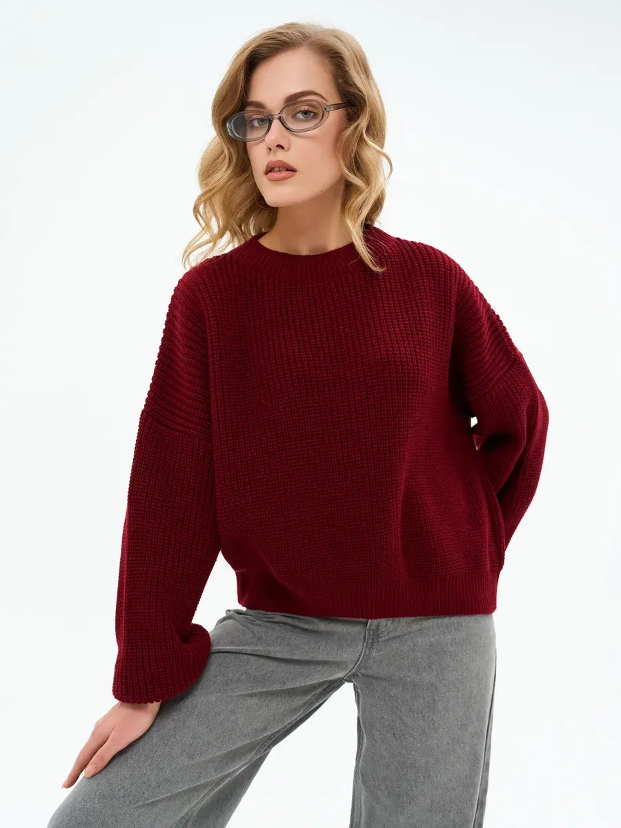 Model wearing the Crimson Charm Sweater by Lauven, an oversized knit in deep burgundy, showcasing comfort and elegance.
