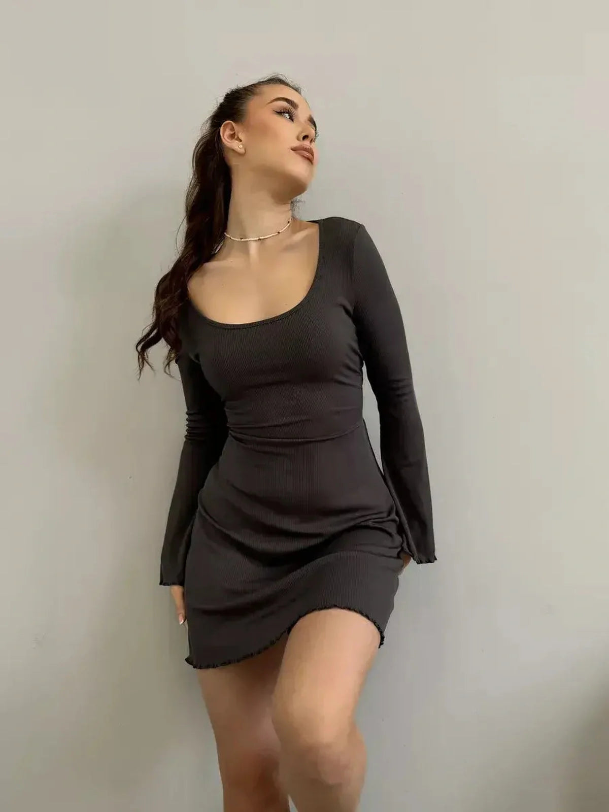 Emily Mini Dress by Lauven in black ribbed knit with long sleeves and flared cuffs, showcasing a square neckline.