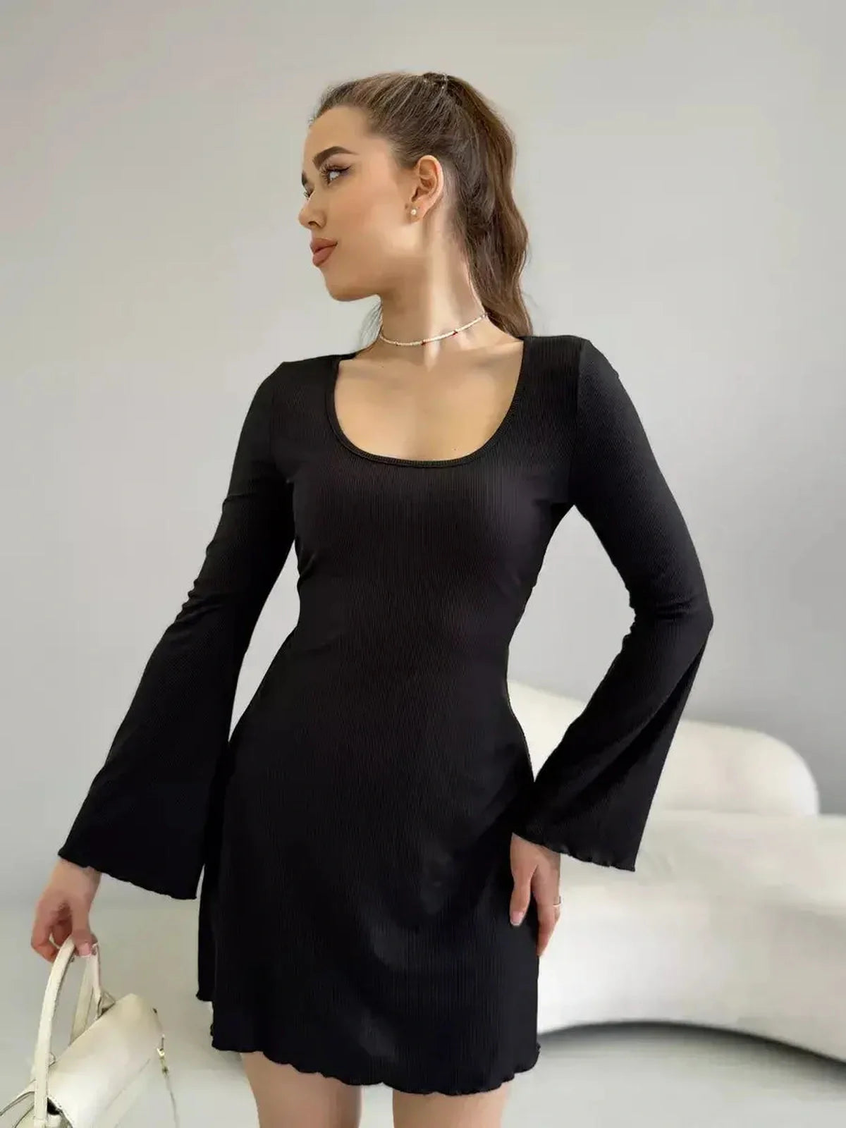 Emily Mini Dress by Lauven in black ribbed knit with long sleeves and flared cuffs.