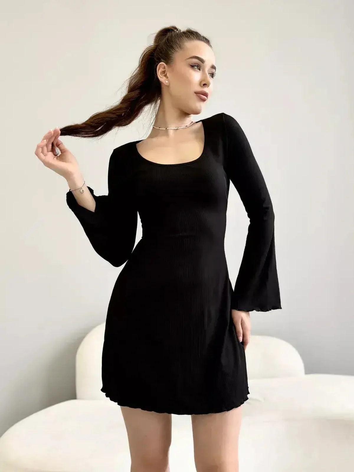 Emily Mini Dress by Lauven in black ribbed knit with square neckline and flared cuffs.