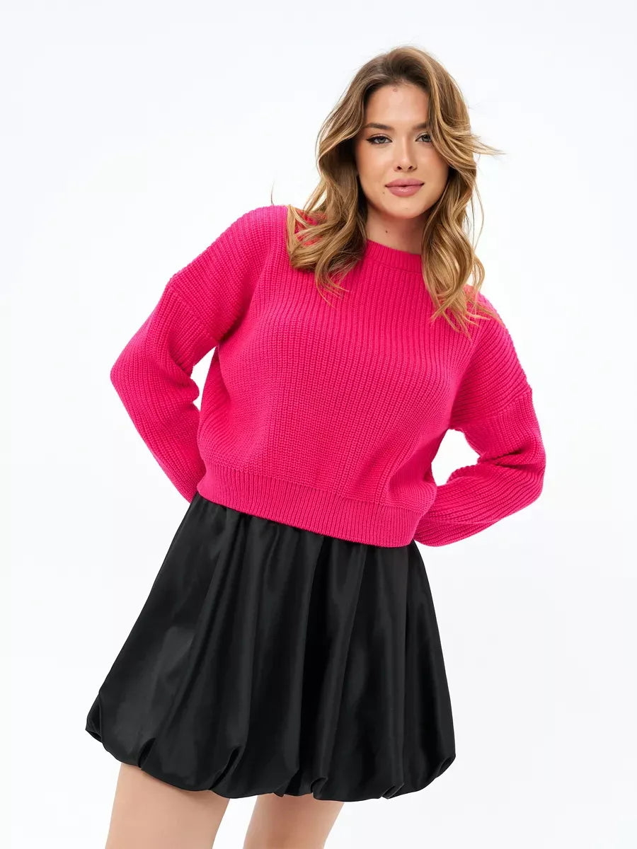 Flamingo Sweater by Lauven in bold fuchsia, oversized knit paired with a black skirt for a chic look.
