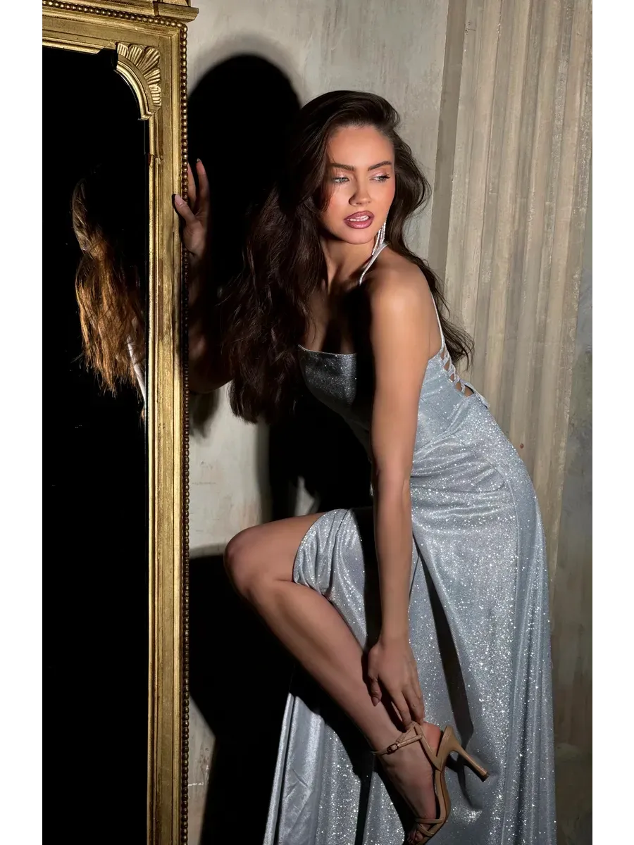 Model showcasing Halo Maxi Dress – Silver Glitter Evening Gown by Lauven, highlighting adjustable back and elegant silhouette.