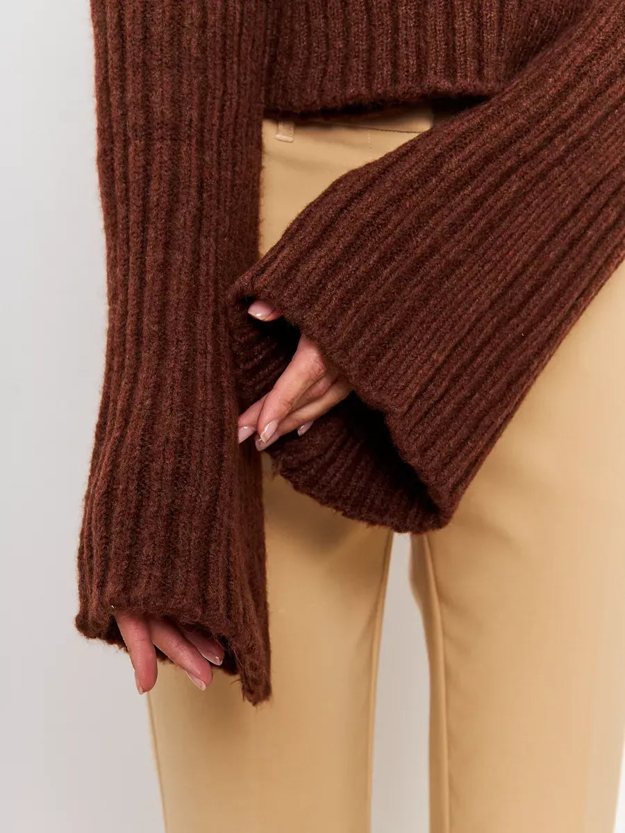 Close-up of wide sleeves of the Orion Sweater by Lauven in rich brown ribbed knit texture.