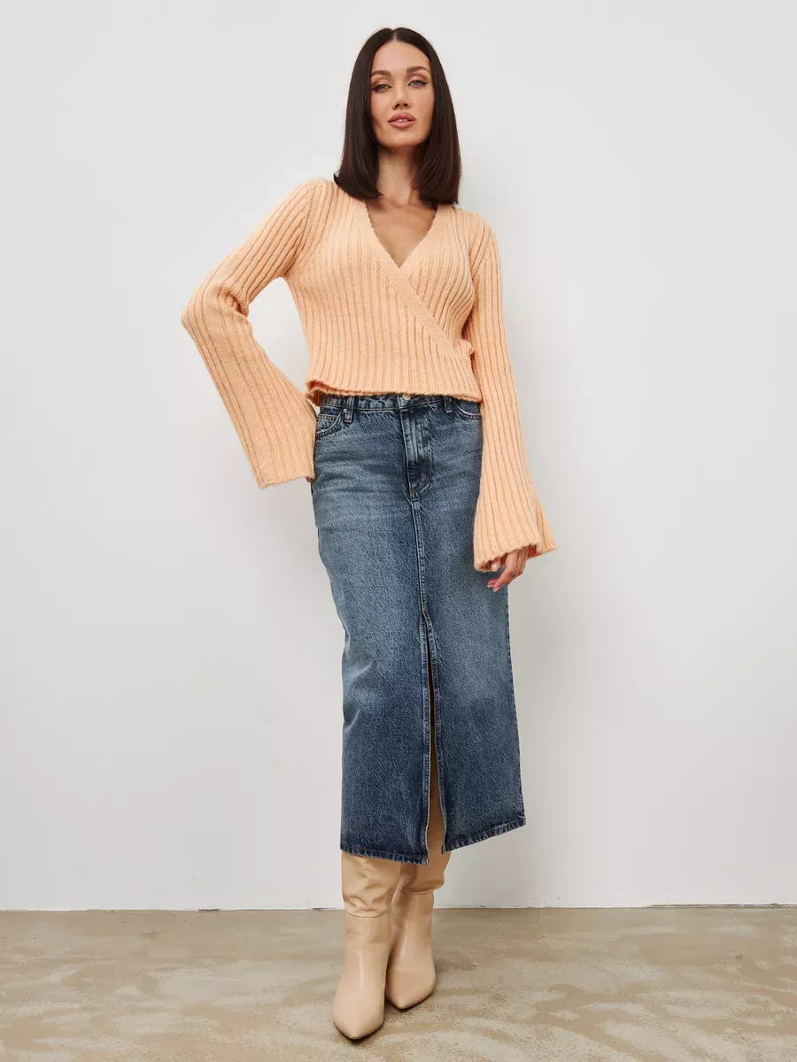 Aurelia Sweater by Lauven, cropped powder knit with V-neck and wide sleeves, styled with a denim skirt.