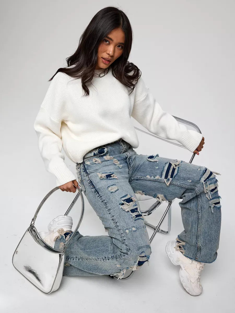 Woman wearing the Celeste Pullover with distressed jeans, showcasing Lauven's oversized cropped women's sweater.