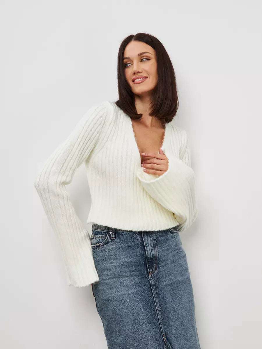 Model showcasing the Lyra Sweater by Lauven in cropped cream knit with V-neck and wide sleeves.