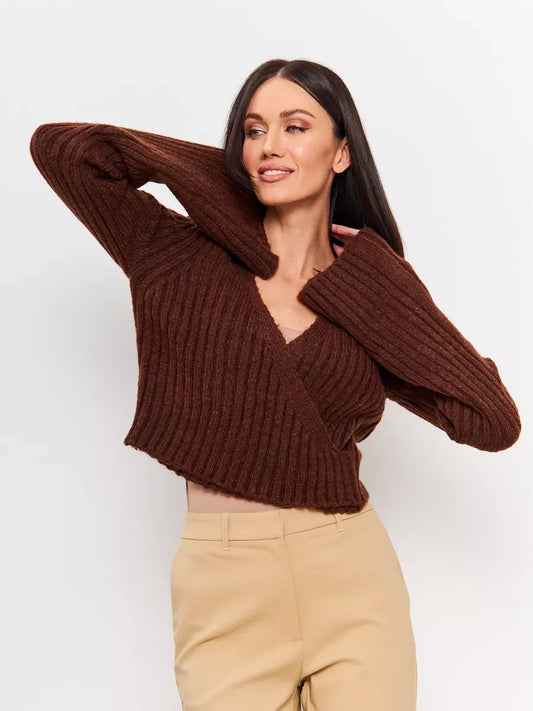 Model wearing the Orion Sweater by Lauven, a cropped brown knit with a V-neck and wide sleeves.