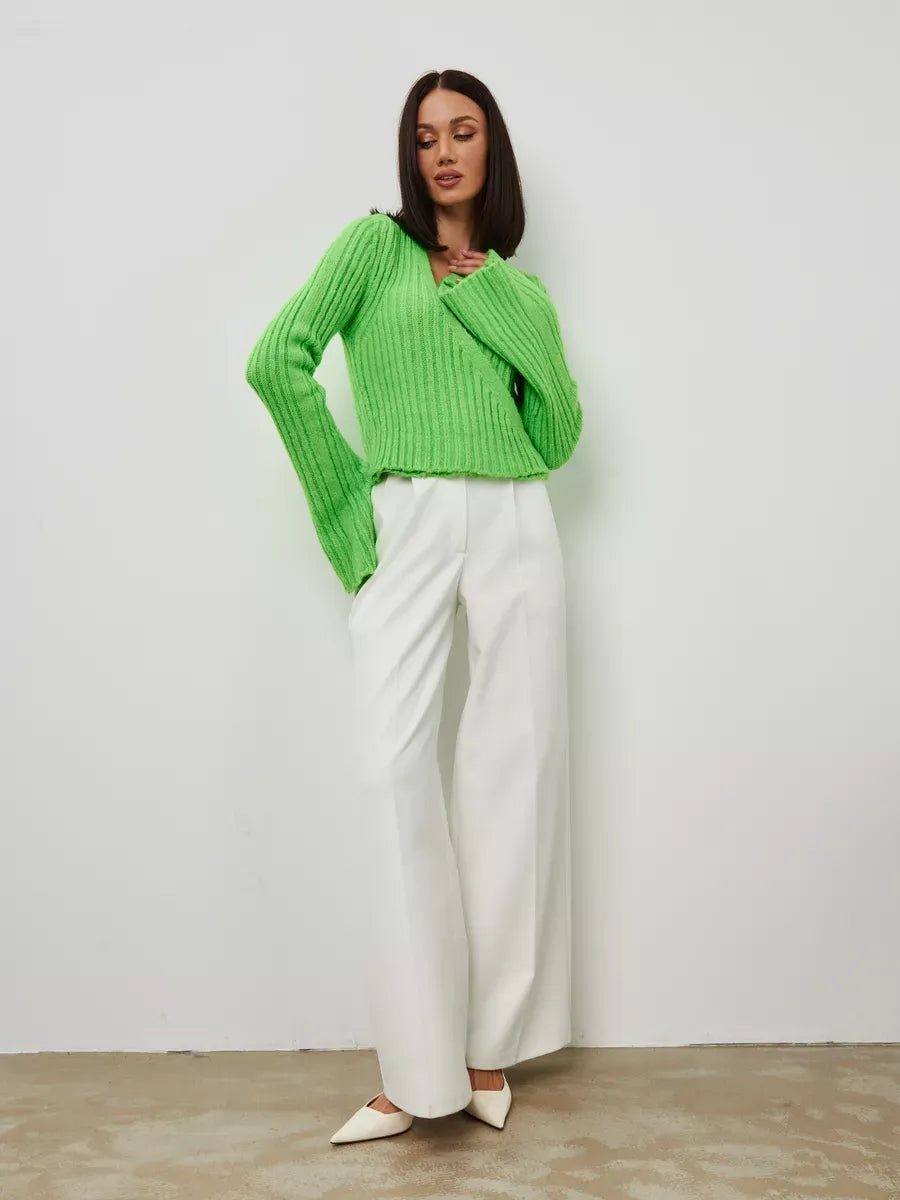 Vega Sweater by Lauven in cropped pistachio knit with V-neck and wide sleeves, paired with white trousers.