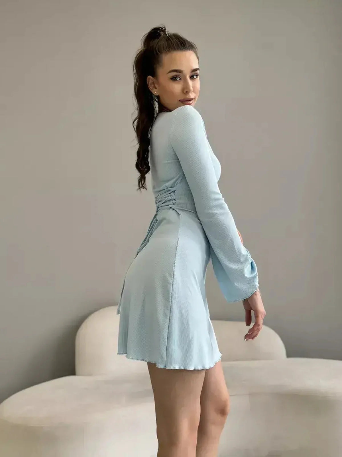 Isabella Mini Dress in soft pastel blue featuring long sleeves and a flared hem by Lauven.