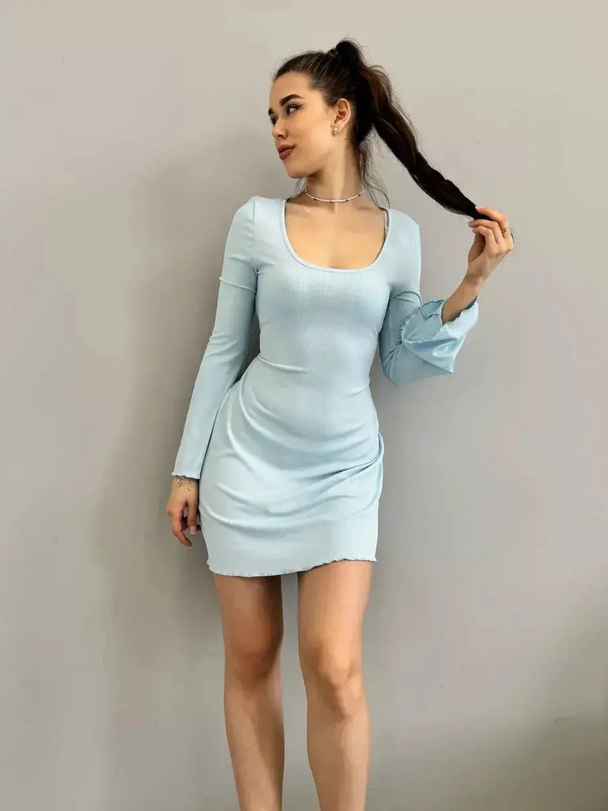 Isabella Mini Dress by Lauven in pastel blue ribbed knit with tie-back and flared hem, model showcasing elegant fit.