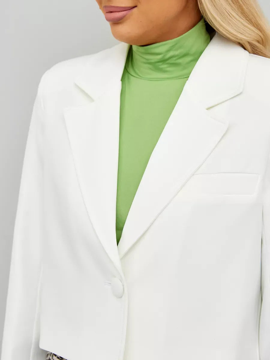 Ivory Blazer by Lauven featuring a cropped silhouette paired with a green turtleneck for a chic look.