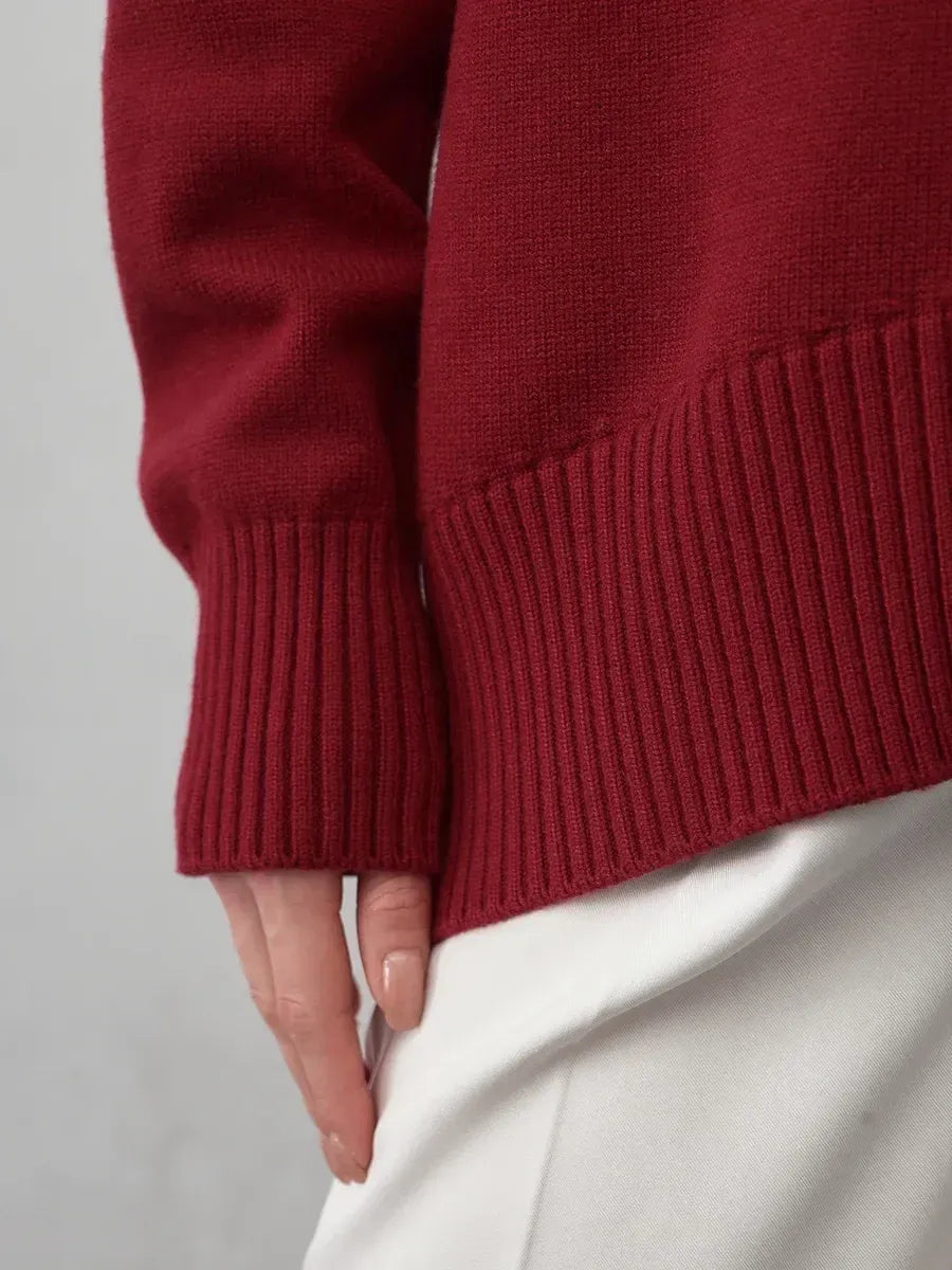 Detail of the Arden Sweater by Lauven, featuring ribbed cuffs and a luxurious burgundy knit.