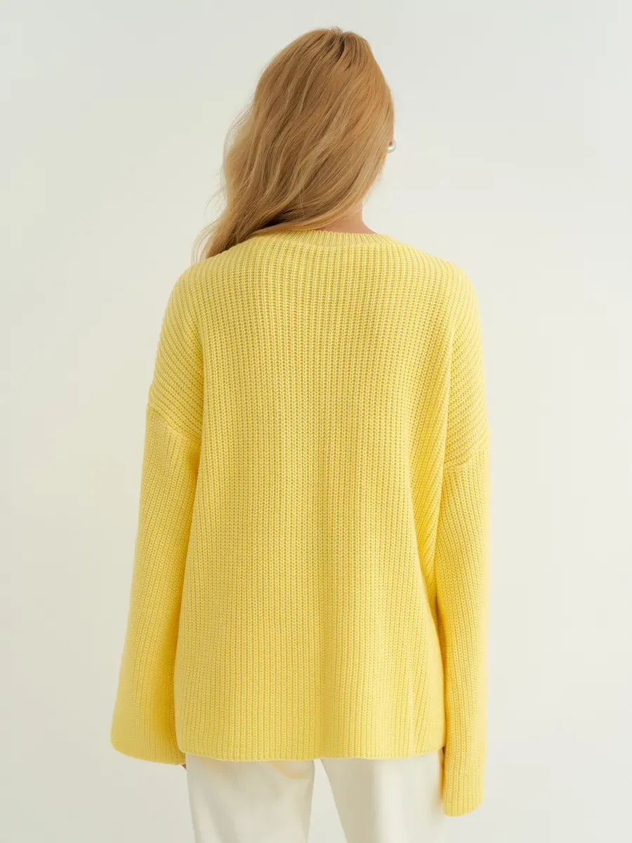 Back view of the Lemonade Sweater by Lauven in soft lemon yellow, showcasing its oversized knit design.