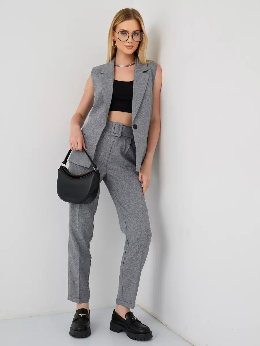 Model showcasing the Luna Suit Set by Lauven, featuring a sleeveless gray vest and high-waist pants.