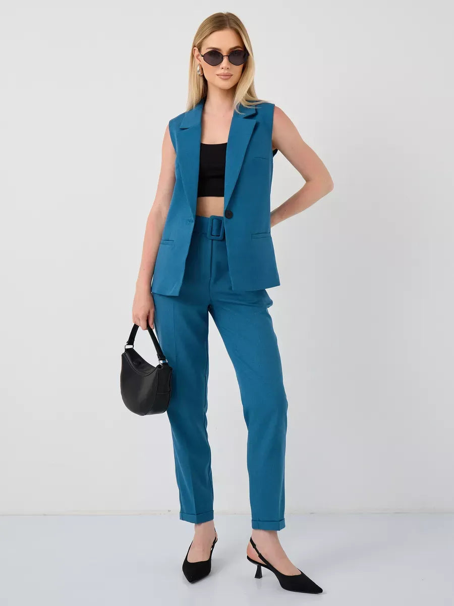 Model wearing Marine Suit Set by Lauven, featuring sleeveless teal vest and high-waist pants, perfect for stylish occasions.