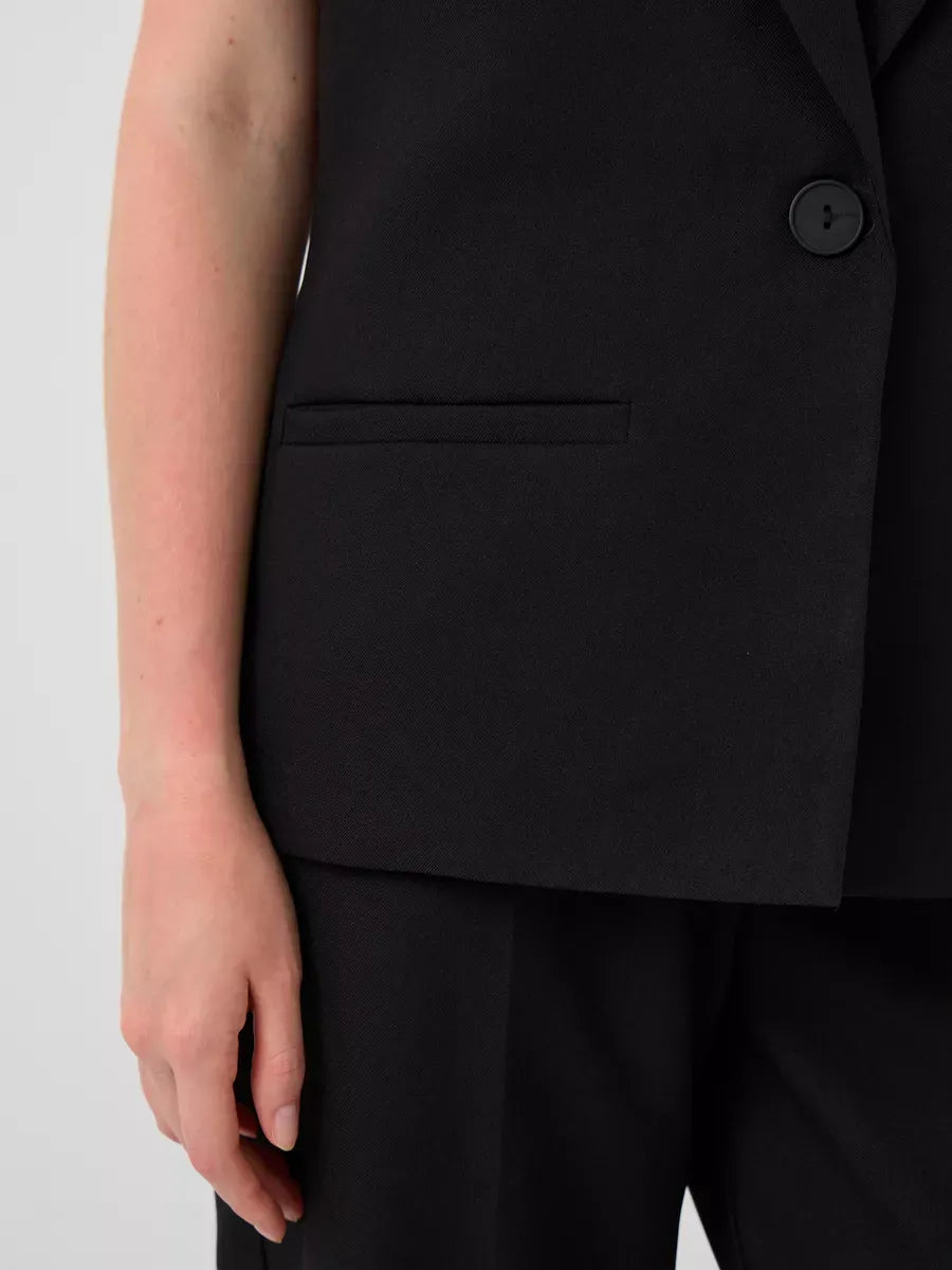 Close-up of the Noir Suit Set by Lauven, showcasing the tailored black vest and pocket detail.