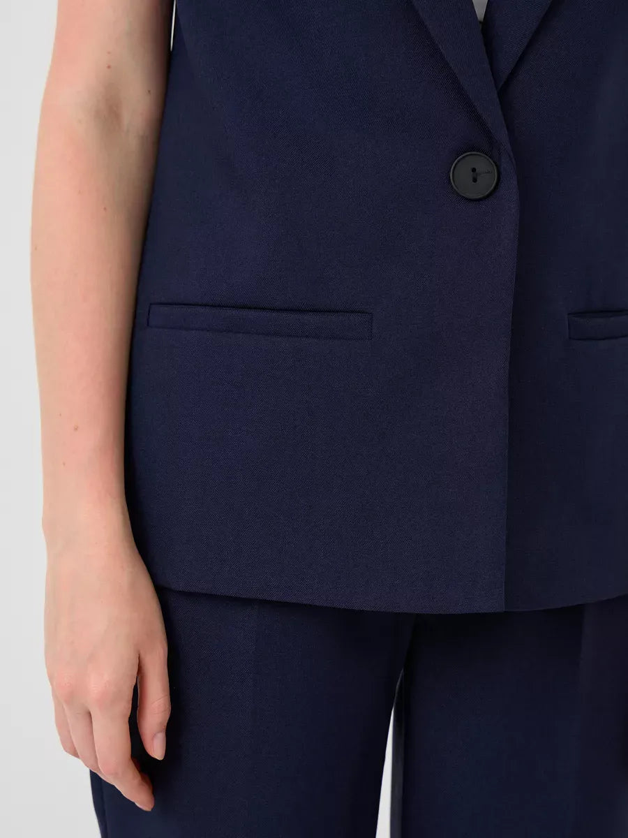Close-up of the tailored vest from the Orion Suit Set by Lauven, showcasing its sleek navy fabric and stylish design.