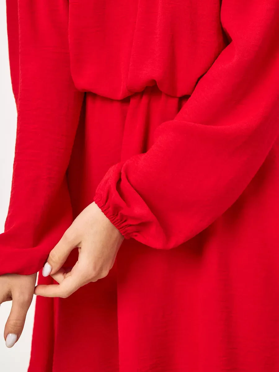 Detail of the elegant long sleeves of the Scarlet Mini Dress by Lauven in rich red fabric.
