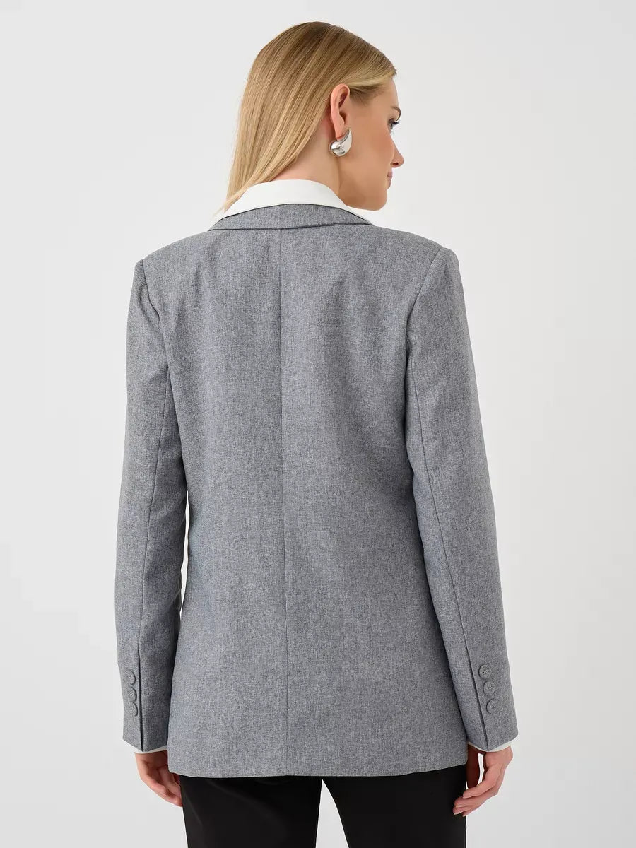 Back view of a woman wearing the Silverstone Blazer by Lauven, showcasing its tailored gray design.