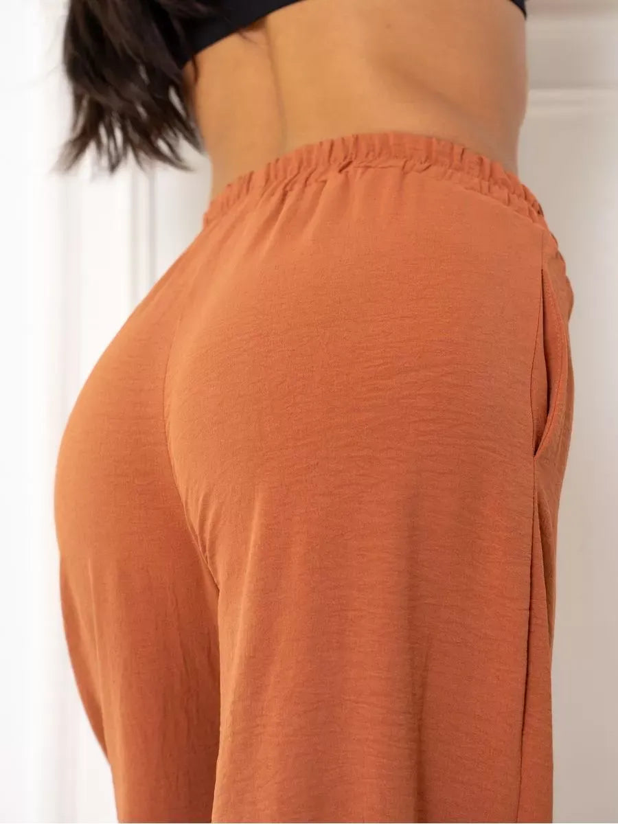 Side view of Terracotta Suit Set by Lauven featuring elegant oversized wide-leg pants in warm brown.