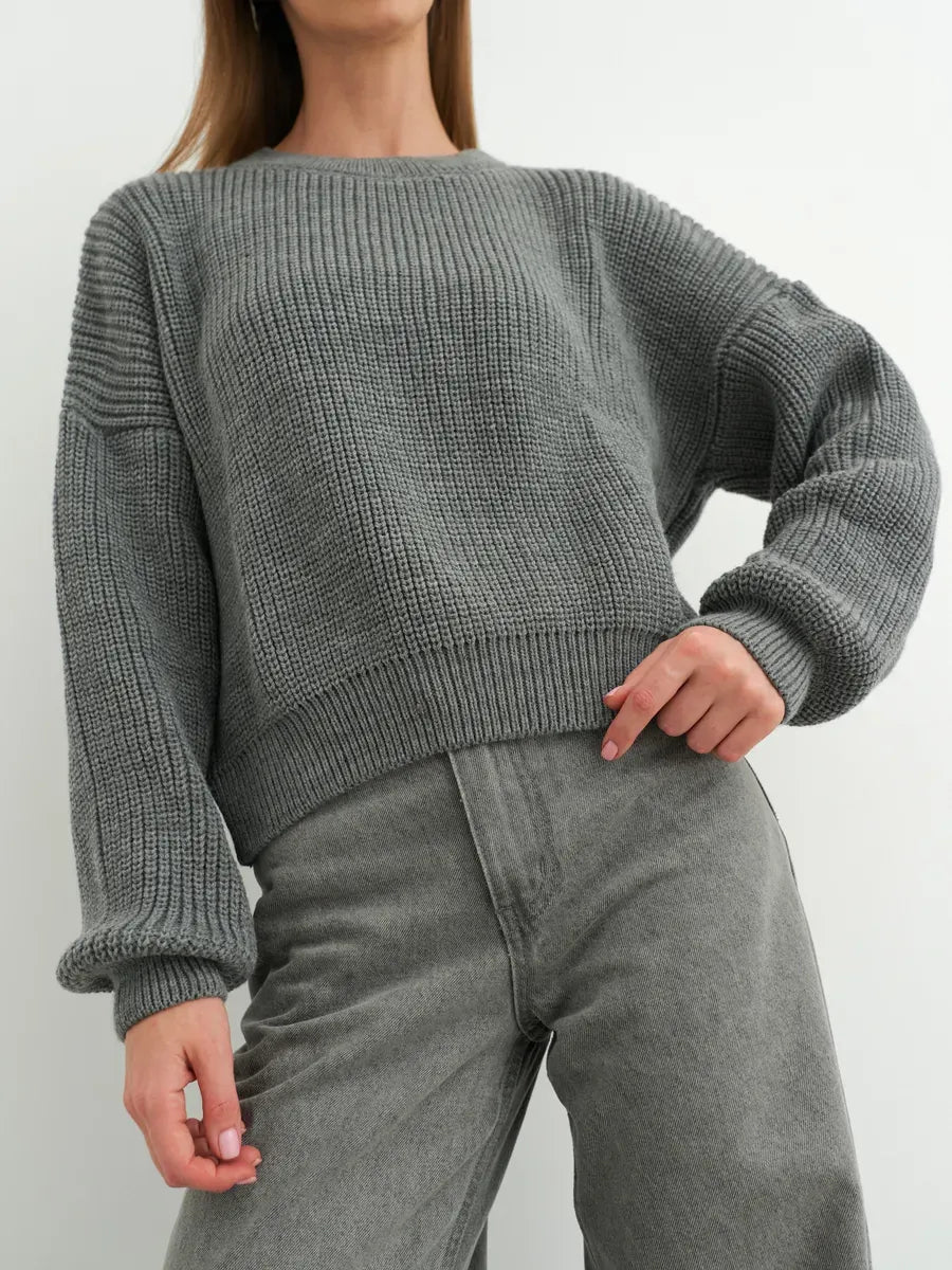 Stylish model wearing a grey oversized Vega Sweater by Lauven, showcasing modern minimalism and cozy elegance.