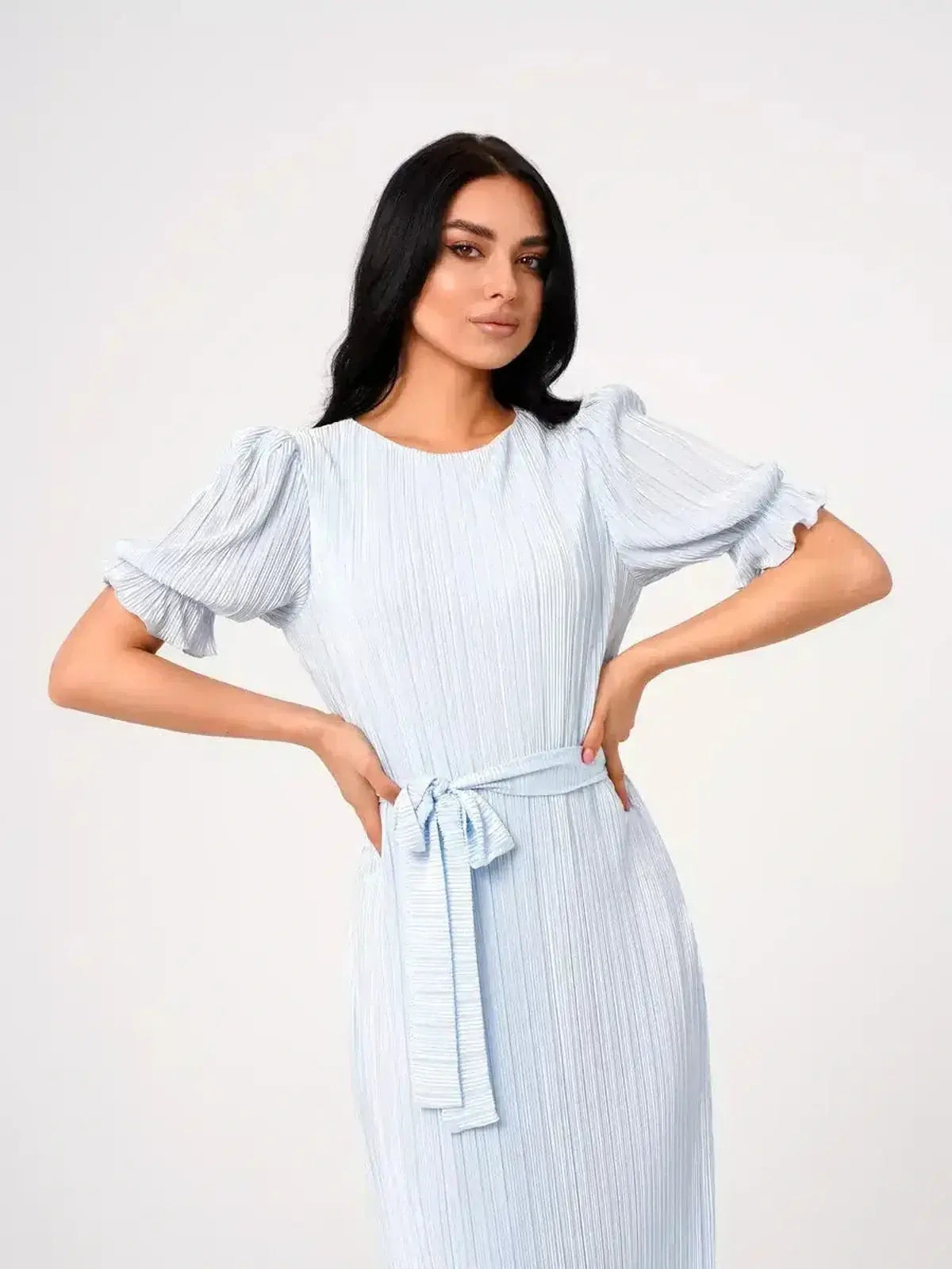 Model wearing the Angel Maxi Dress in light blue with pleated details and a self-tie waist belt.