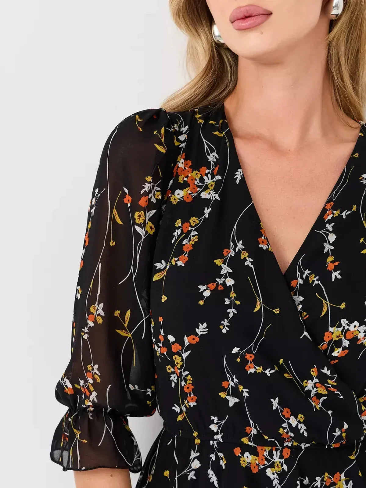 Lotus Mini Dress by Lauven featuring a black floral print, deep V-neckline, and 3/4 puff sleeves.