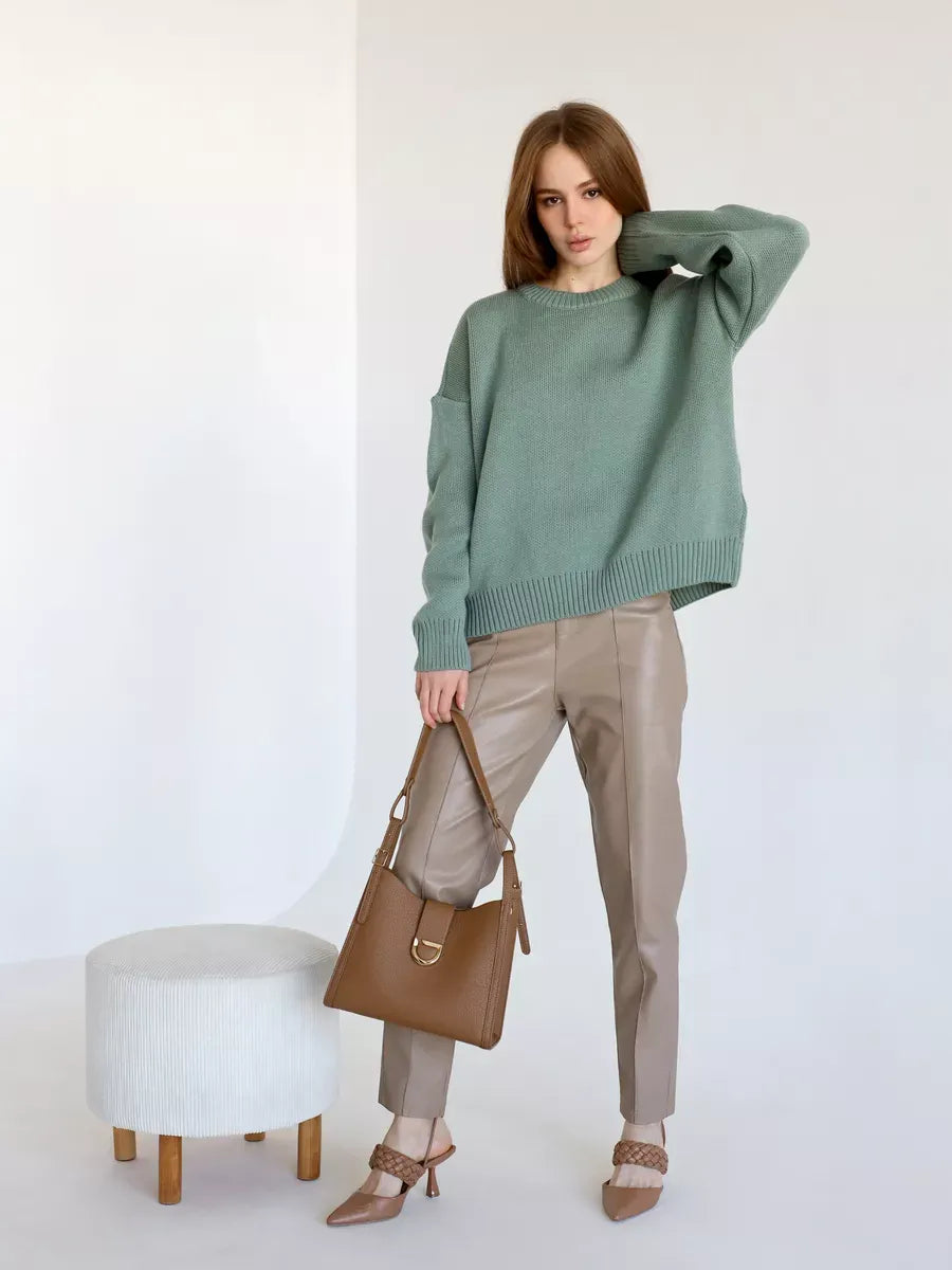Lauven Lyra Pullover in soft pistachio green, oversized cropped women's sweater styled with beige pants and handbag.