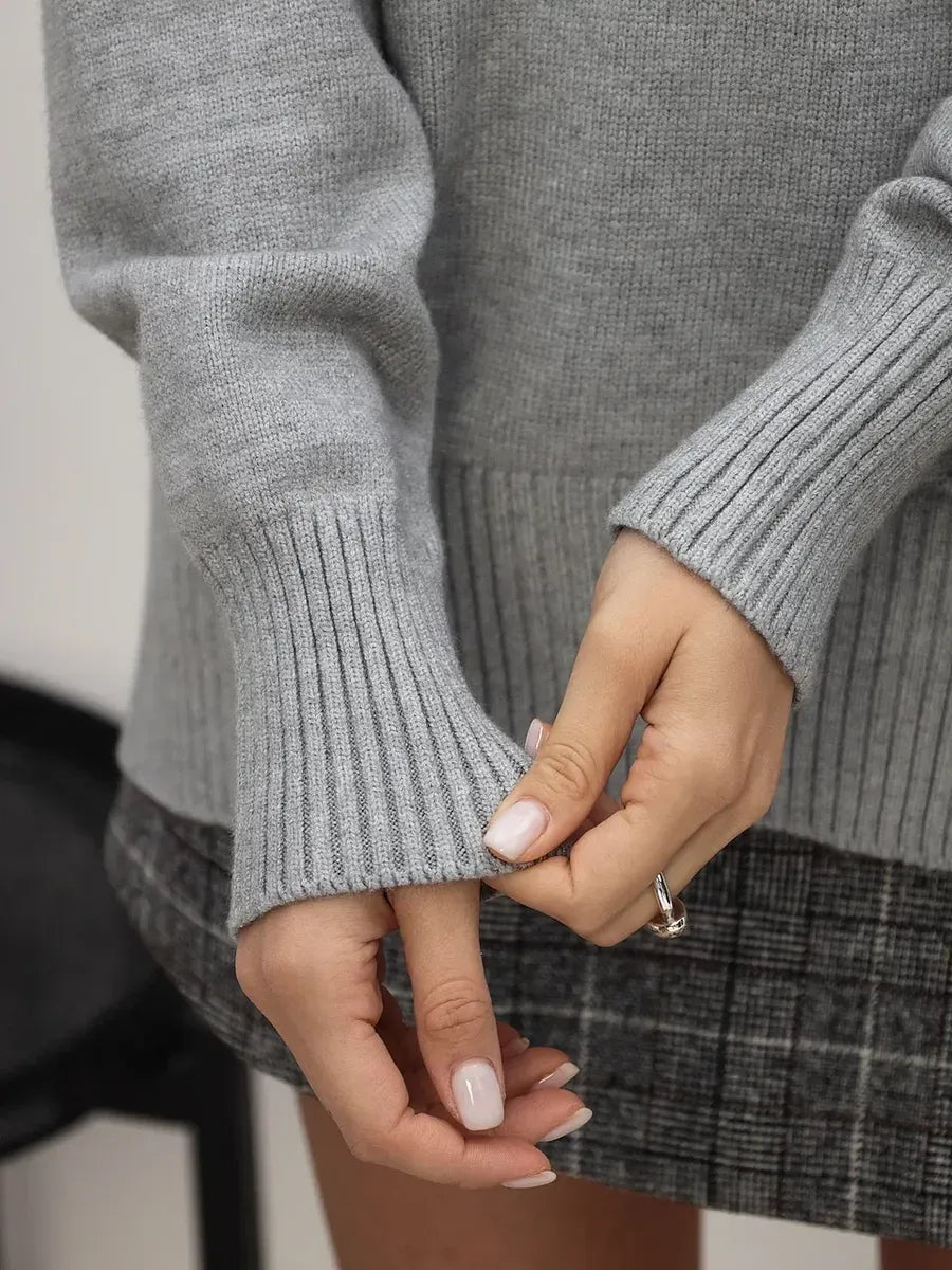 Lyra Sweater from Lauven, showcasing light grey knitwear with relaxed sleeves and ribbed cuffs.