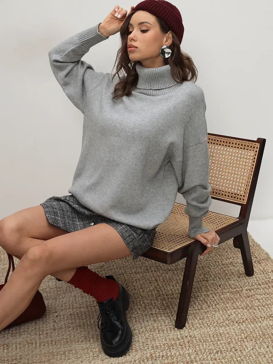 Lyra Sweater by Lauven in light grey, a cozy turtleneck knitwear essential, styled with a chic outfit.