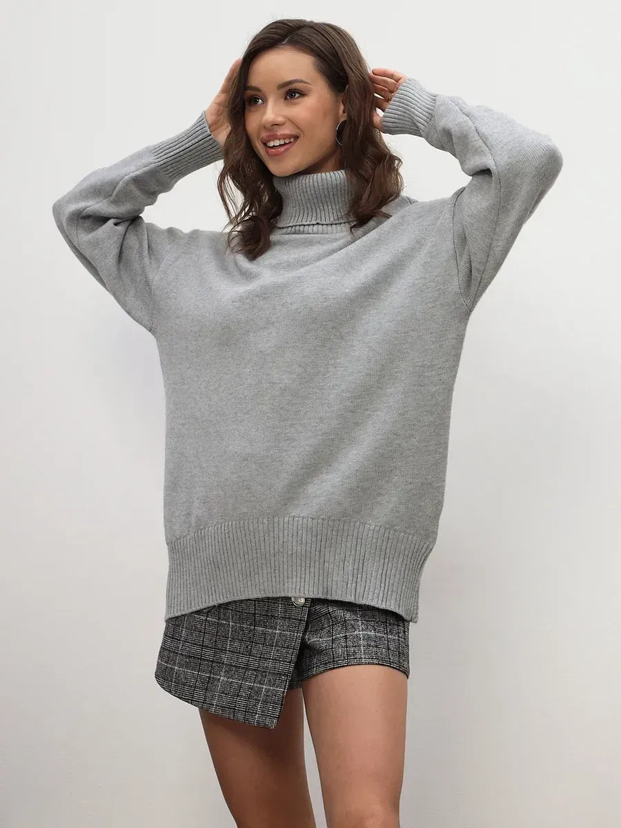 Woman wearing the Lyra Sweater from Lauven, a light grey turtleneck knitwear essential.