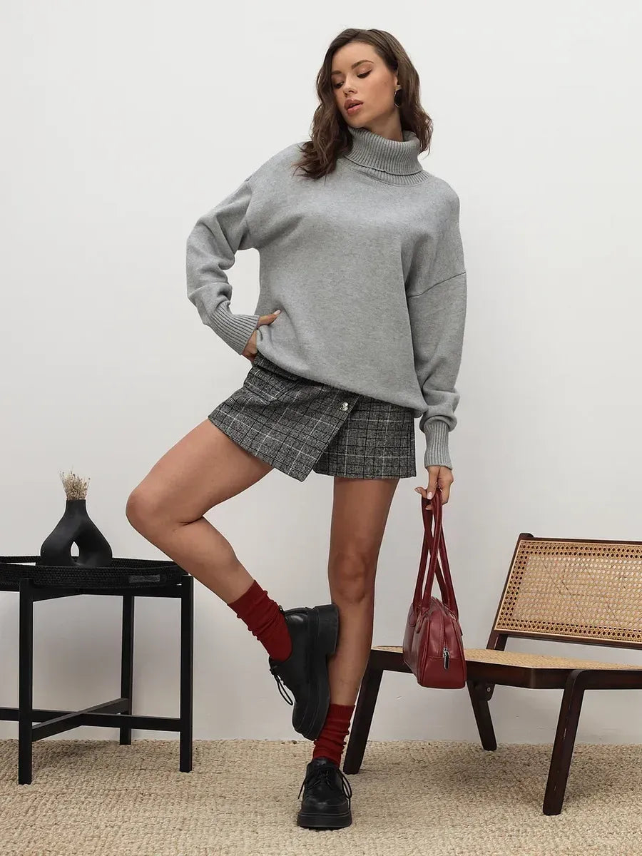 Lyra Sweater by Lauven in light grey worn with a skirt, showcasing cozy sophistication and relaxed minimalism.