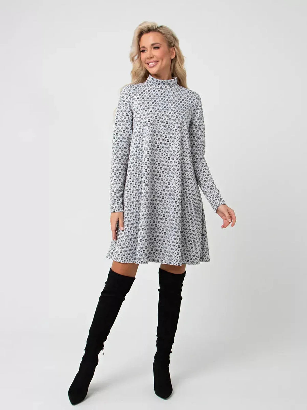 Model wearing the Maia Mini Dress by Lauven, a graphite grey A-line dress with long sleeves and stand collar.