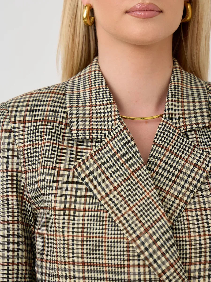 Close-up of the Maple Blazer by Lauven featuring a brown checked pattern and structured collar detail.