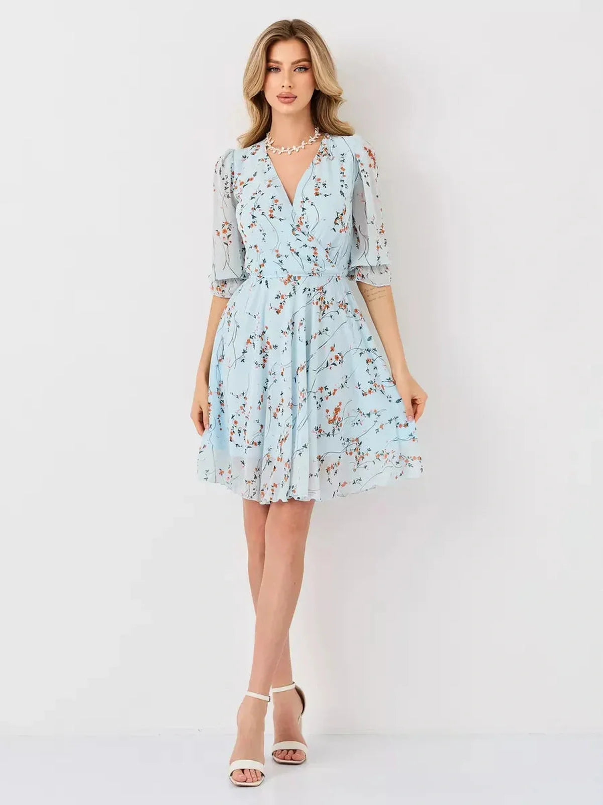 Mara Mini Dress by Lauven, light blue floral wrap dress with V-neckline and A-line silhouette.