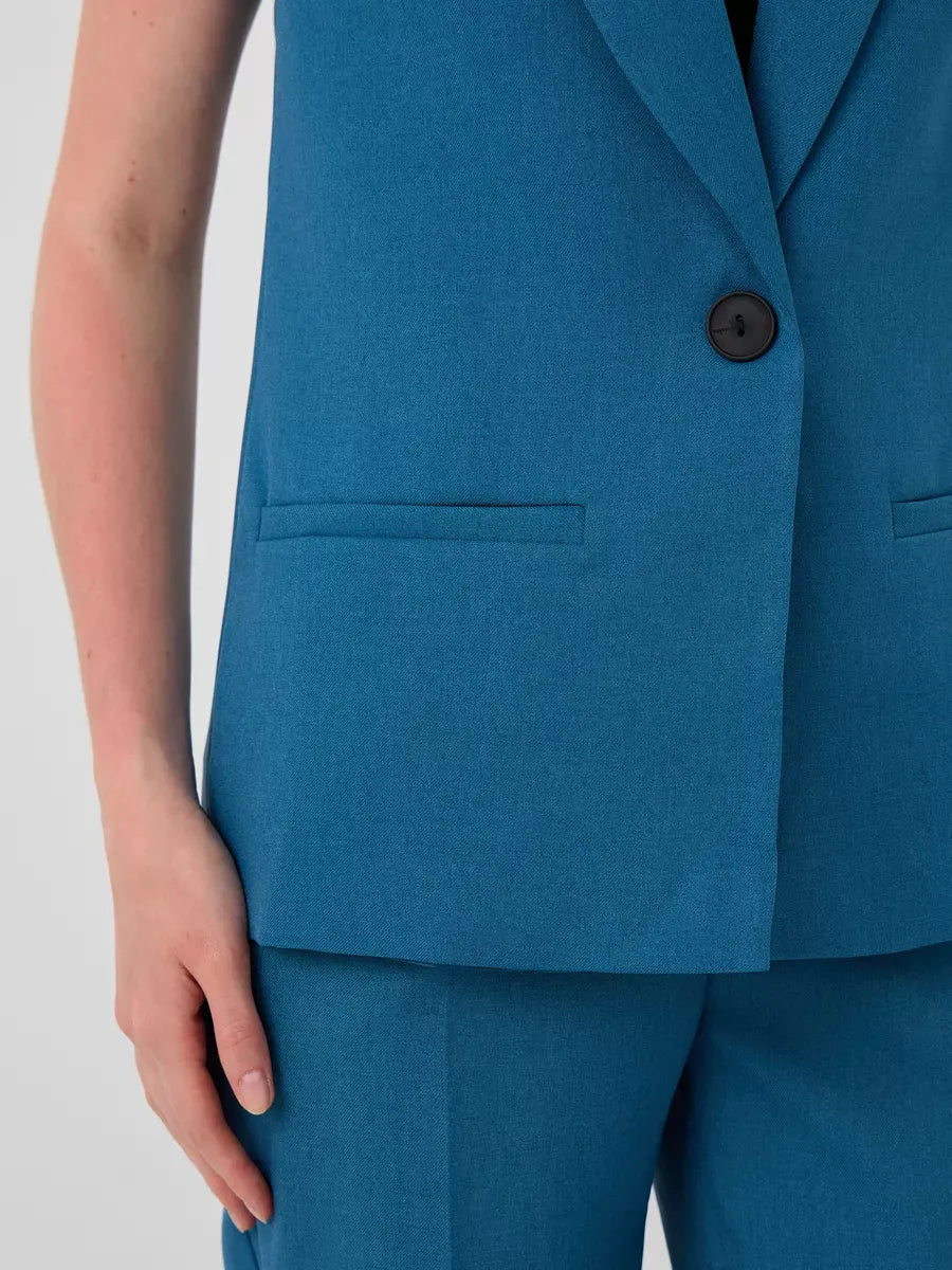 Marine Suit Set by Lauven featuring a sleeveless teal vest with button and pockets, showcasing modern fashion.
