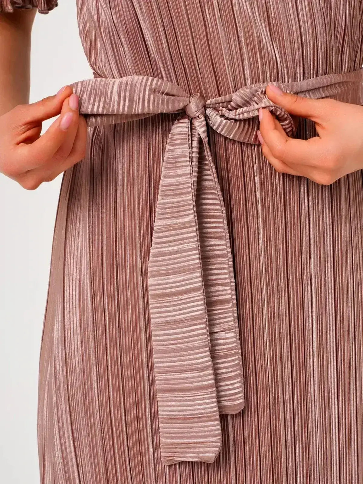 Close-up of the elegant tie detail on the Lauven Noa Maxi Dress showcasing its pleated texture.