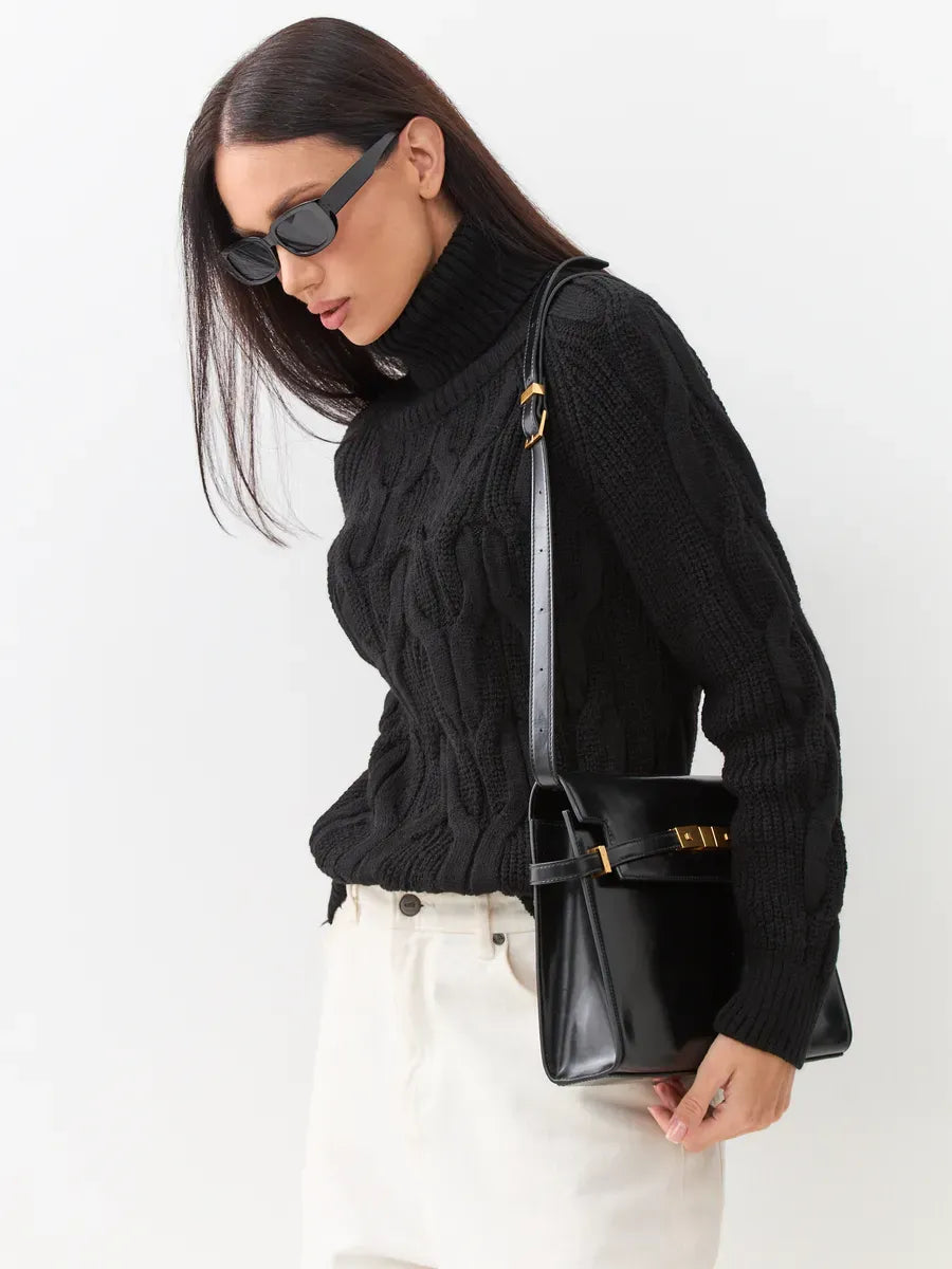 Elegant woman wearing Noir Knitwear turtleneck sweater with a stylish black bag, showcasing modern fashion by Lauven.
