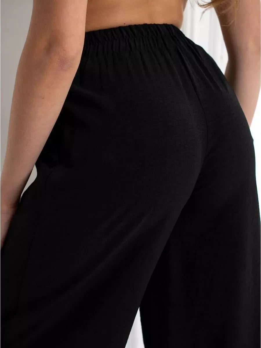 Close-up of wide-leg trousers from the Noir Suit Set by Lauven, showcasing stylish comfort in classic black.