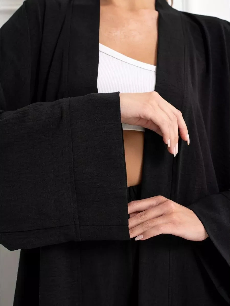 Model showcasing the chic Noir Suit Set by Lauven, featuring an oversized black jacket with wide sleeves.