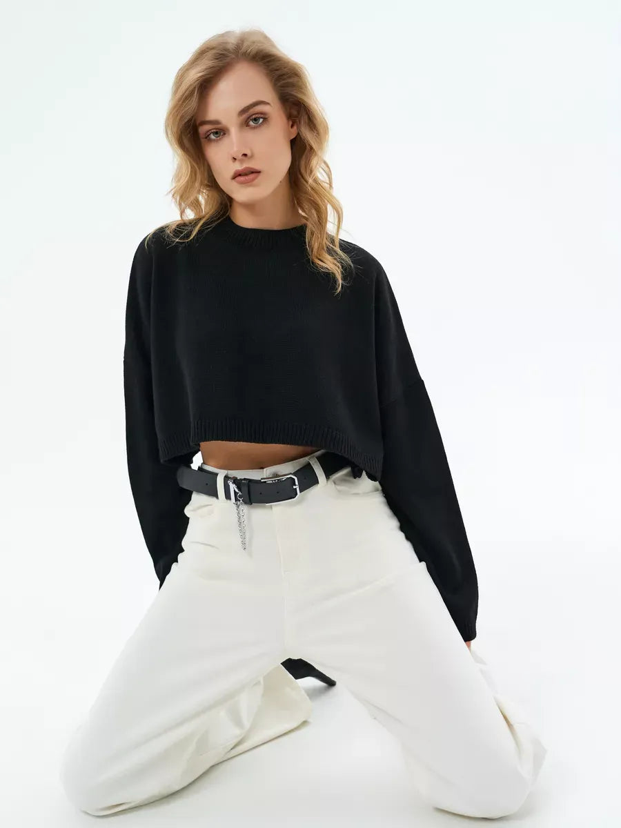 Onyx Sweater by Lauven - Cropped oversized knit in black, styled with white pants, perfect for a modern, minimalistic look.