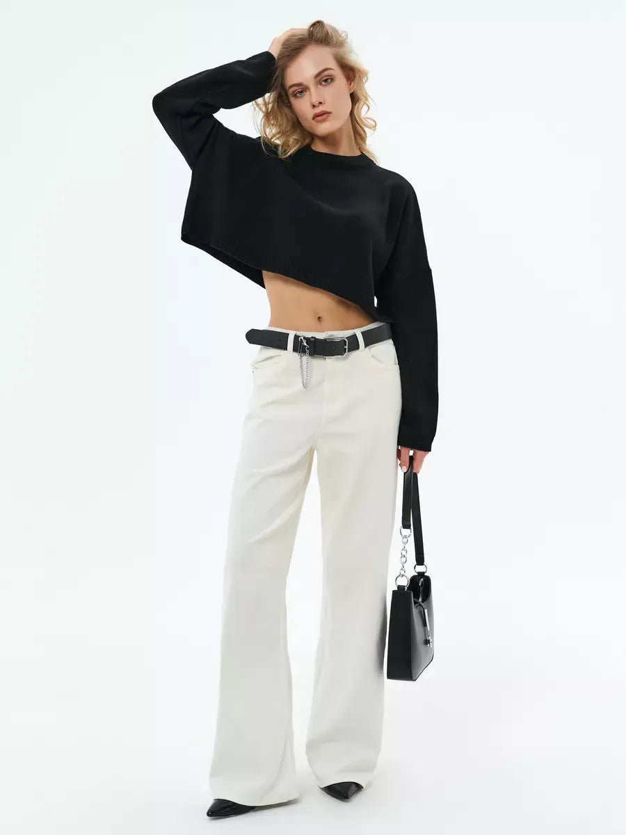 Onyx Sweater by Lauven - Cropped oversized black knit, styled with white trousers for a trendy minimalist look.